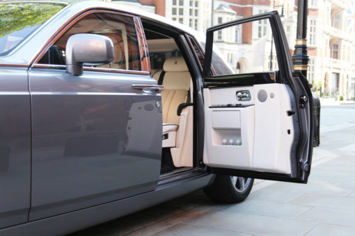 Chauffeur-driven Rolls-Royce Phantom with rear door open