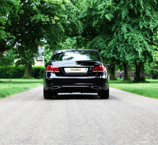 Rear view of Mercedes E Class chauffeur-driven car