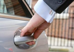 Chauffeur opening wedding car door