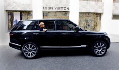 Range Rover chauffeur car exterior with passenger looking out of rear window