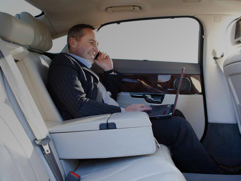 Passenger in back of luxury chauffeur car