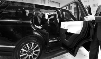 Range Rover Autobiography chauffeur holding door open for passenger to alight