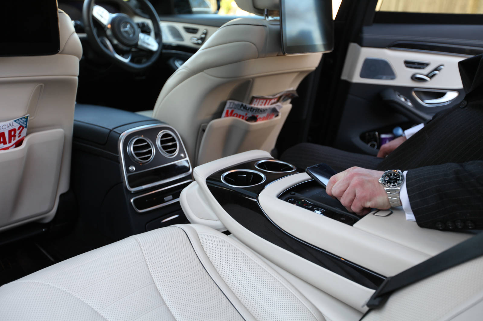 Passenger on back seat of chauffeur-driven vehicle