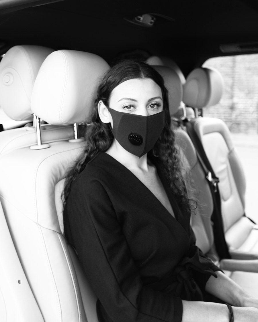 female passenger in chauffeur vehicle wearing mask