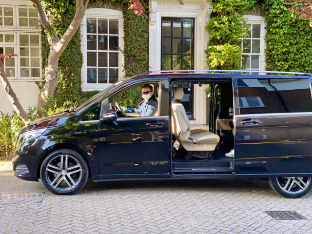 Chauffeur wearing a coronavirus mask in a V-Class