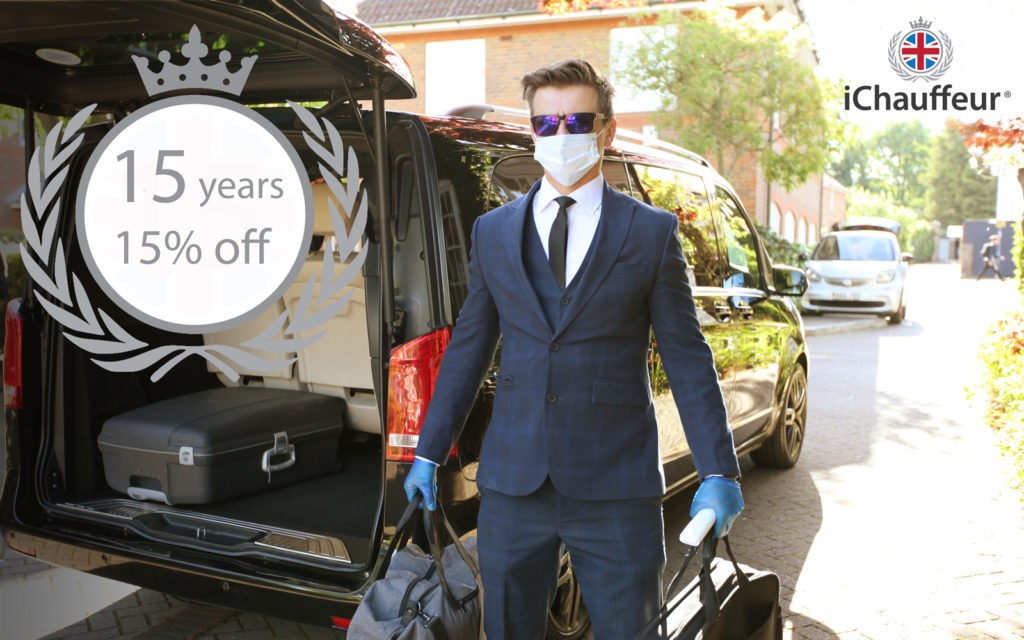 Chauffeur with mask carrying luggage