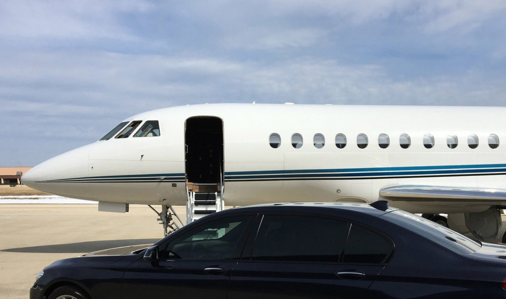 Private jet with chauffeur vehicle on the runway