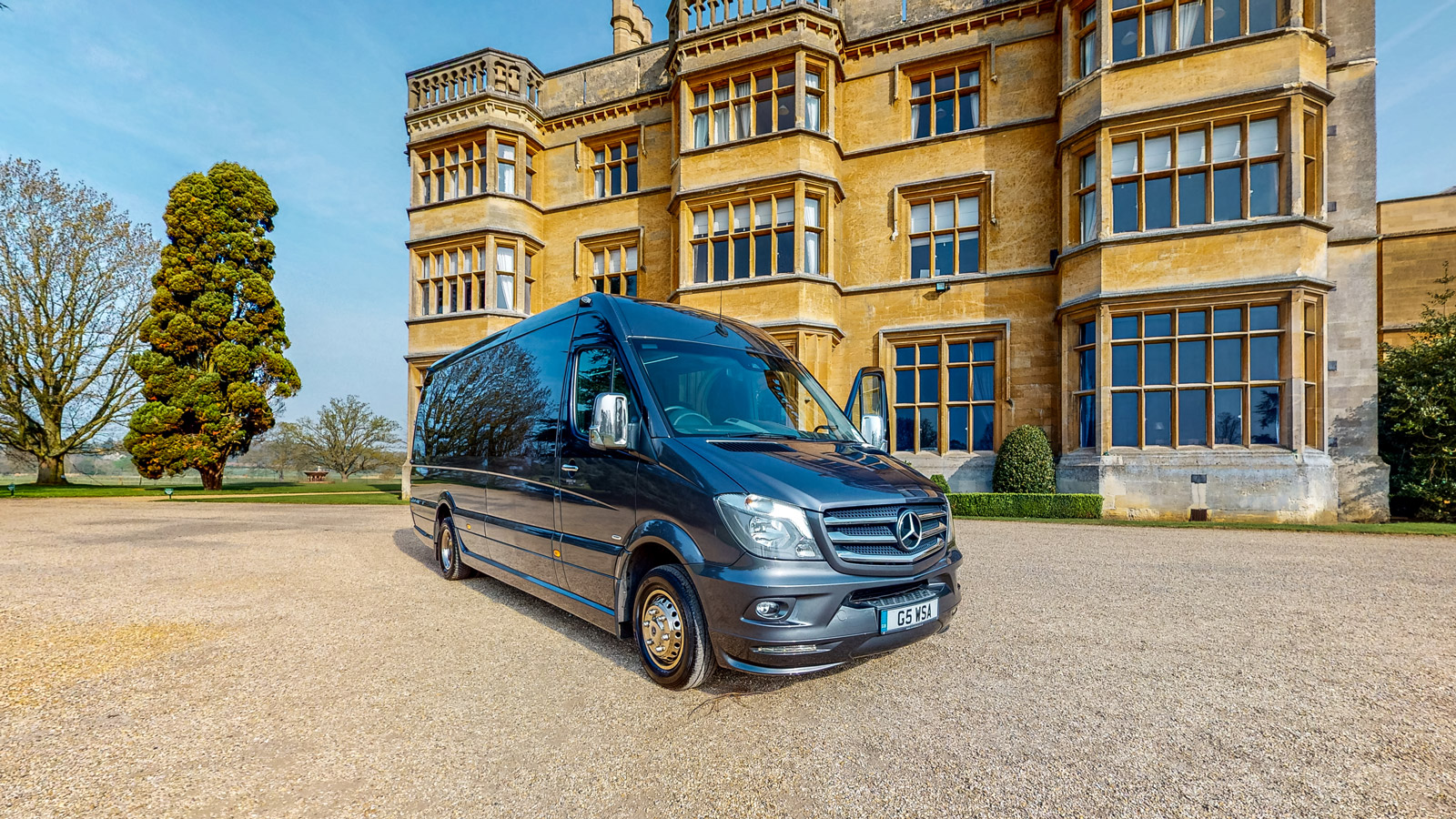 Luxury Minibus in grey outside a stately home