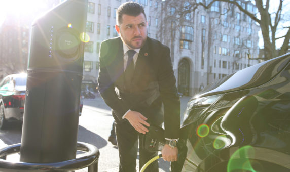 Chauffeur charging luxury electric Mercedes EQV in Central London
