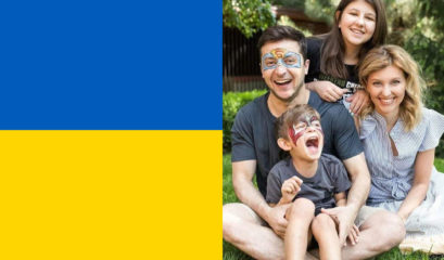 President Zelensky and smiling family and the Ukrainian flag