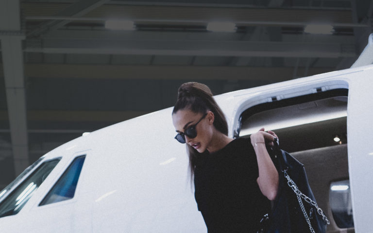 Celebrity female private jet passenger disembarking a private jet