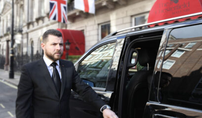 London Airport Layover Private Chauffeur Tour. Chauffeur beside V-Class outside hotel in Mayfair, London