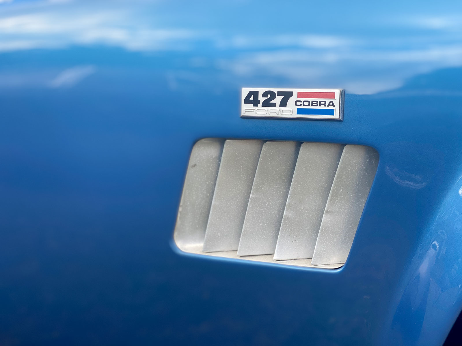 427 Ford Cobra badge on blue AC Shelby Cobra