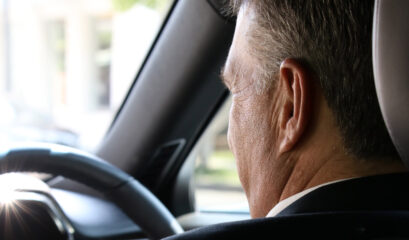 Chauffeur behind wheel of chauffeur car