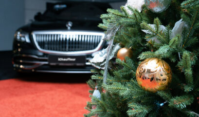 Christmas tree in front of luxury Maybach Mercedes car