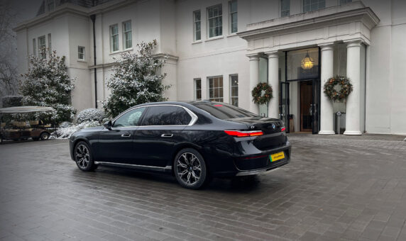 Black BMW i7 chauffeur car in front of Coworth Park, Ascot.