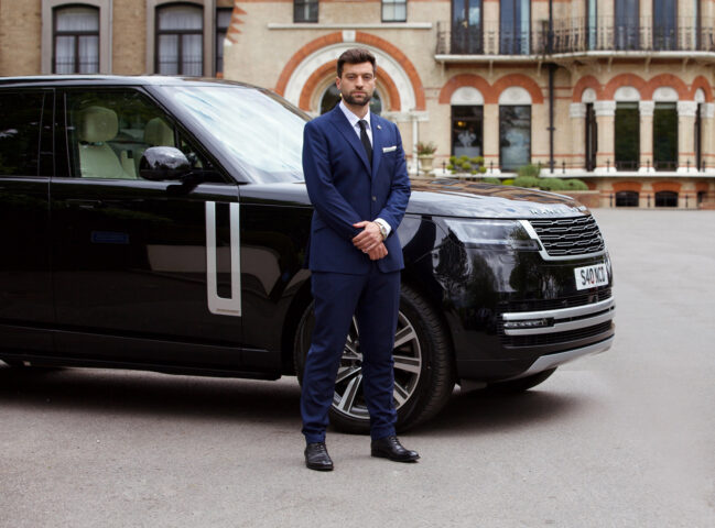 Chauffeur in front of Range Rover chauffeur car