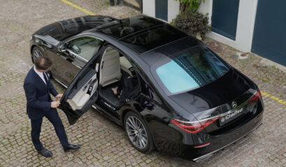 corporate chauffeur closing door of S-Class Mercedes